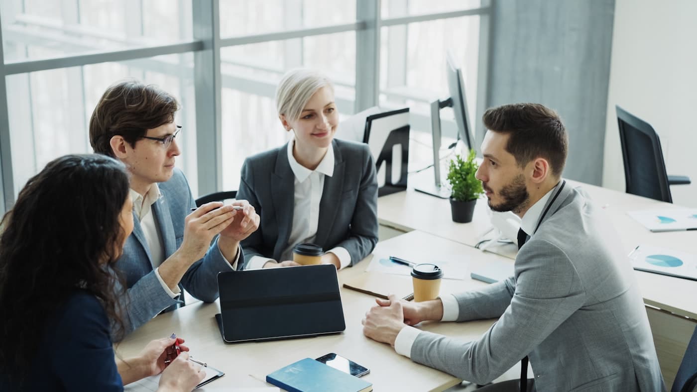 A dedicated Middleman team meeting in a modern office